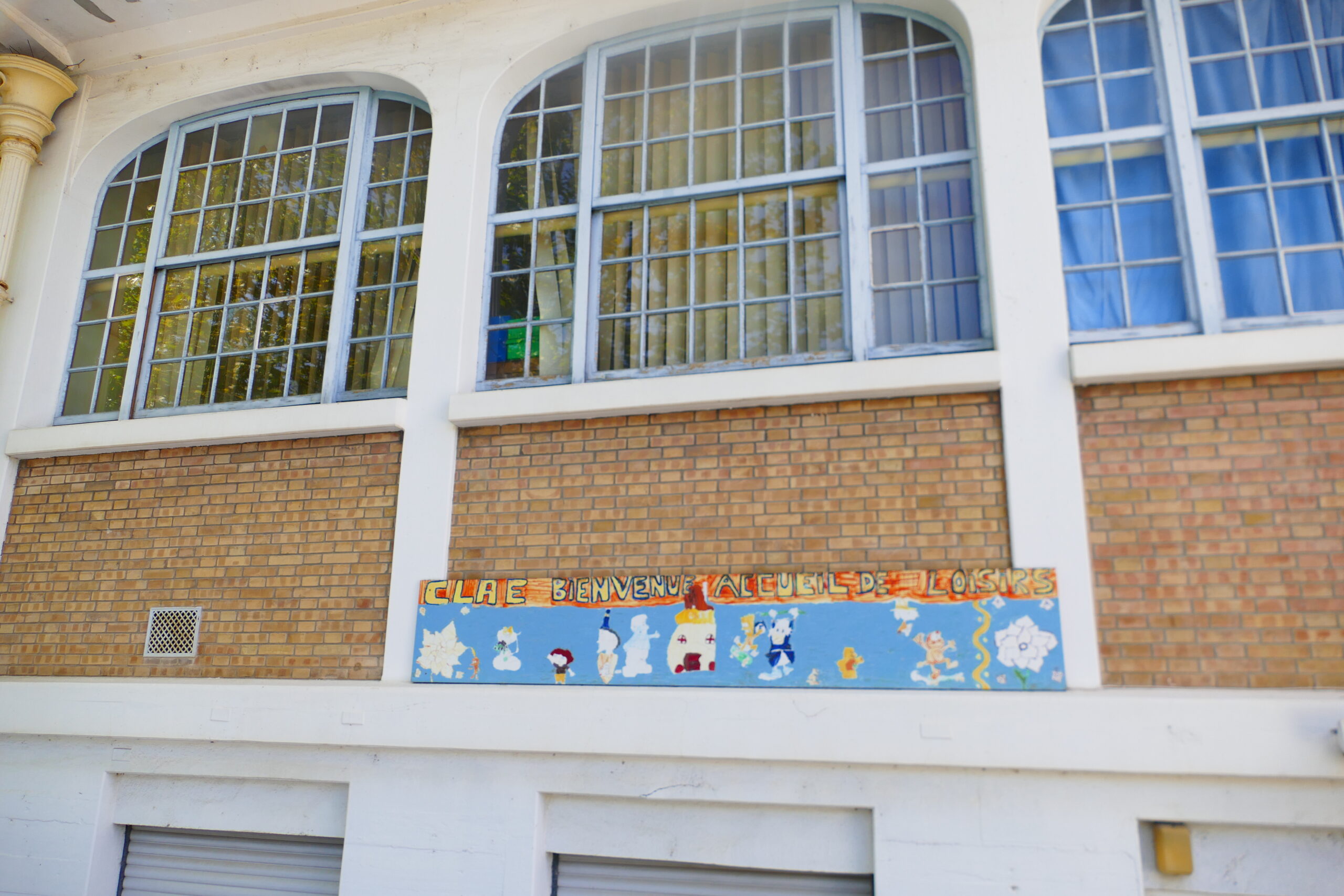 Photo de la façade du claé de Saint-Benoit de Carmaux Photo de la façade du claé de Saint-Benoit de Carmaux. une large pancarte y est accrochée sur laquelle est représenté des fleurs et marqué "Claé, Bienvenu. Accueille de loisir"